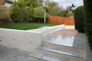 Italian Porcelain patio with new retaining walls, new lawn and a sleeper flower bed 1