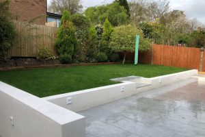 Italian Porcelain patio with new retaining walls, new lawn and a sleeper flower bed 3