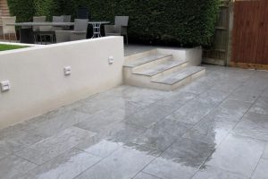 Italian Porcelain patio with new retaining walls, new lawn and a sleeper flower bed 5