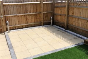 Patio with outdoor lighting, artificial grass with a sleeper flower bed 2