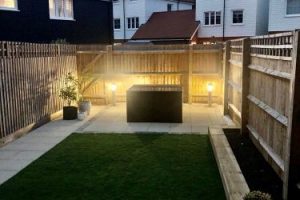 Patio with outdoor lighting, artificial grass with a sleeper flower bed 4