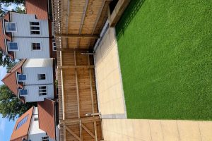 Patio with outdoor lighting, artificial grass with a sleeper flower bed 5