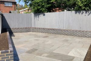 Grey Indian sandstone patio with Staffordshire blue brick planters 3
